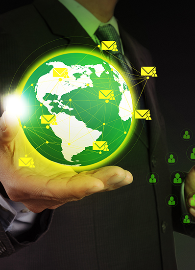A man in a suit holding a green globe with icons representing technology and sustainability.